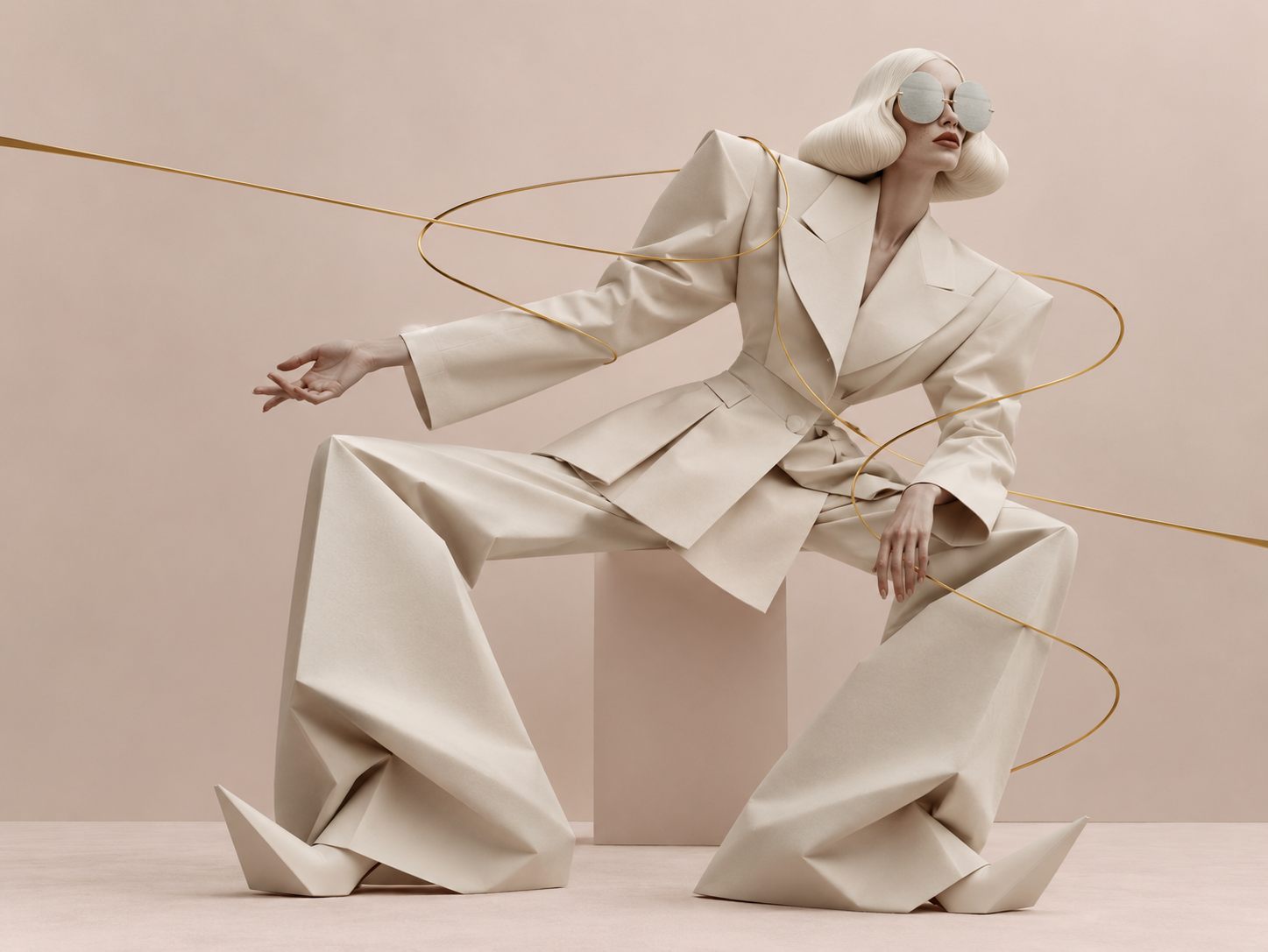 Surreal figure with platinum hair, large mirrored glasses and an ivory suit with elongated architectural proportions, crossed by a thin gold line
